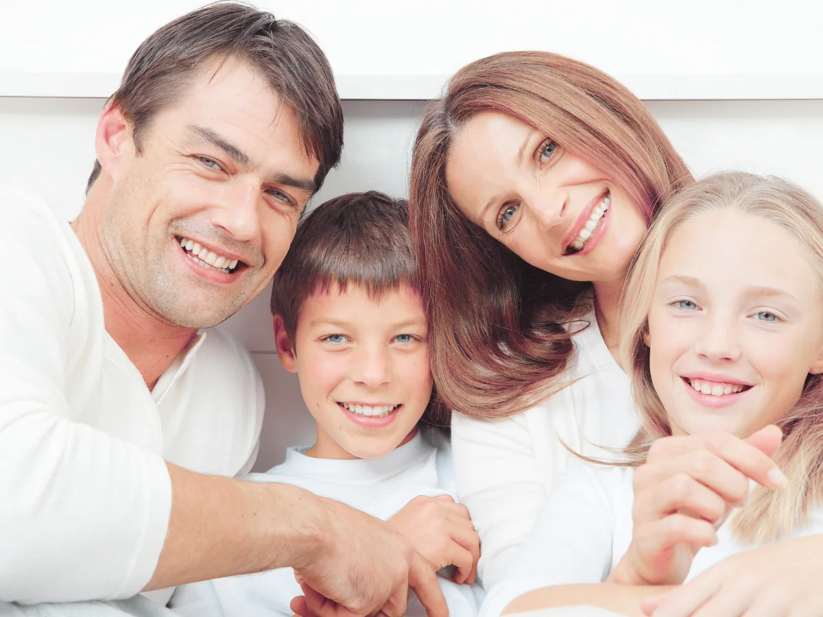 Family Dentist Advantages: Whole Household Care | North Toronto Dental Centre Smiling family of four showing healthy teeth and the benefits of whole household dental care
