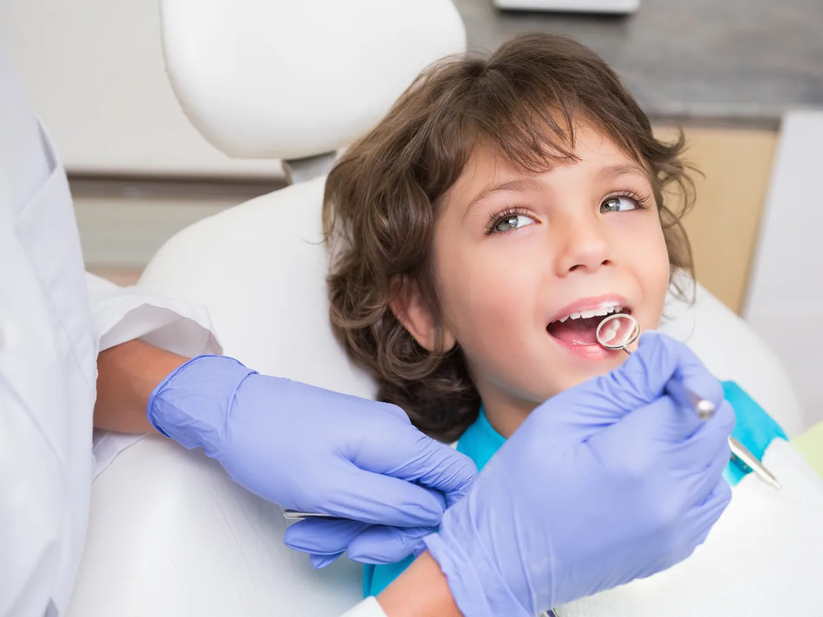 Dentist on Avenue Rd | Child-Friendly Pediatric Care at North Toronto Dental Centre Young child receiving a gentle dental exam from a pediatric dentist on Avenue Rd