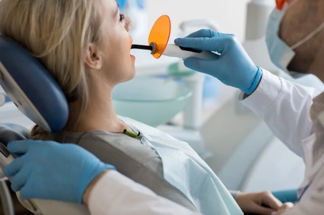Tooth fillings North York, dentist placing a tooth-coloured composite filling at North Toronto Dental Centre