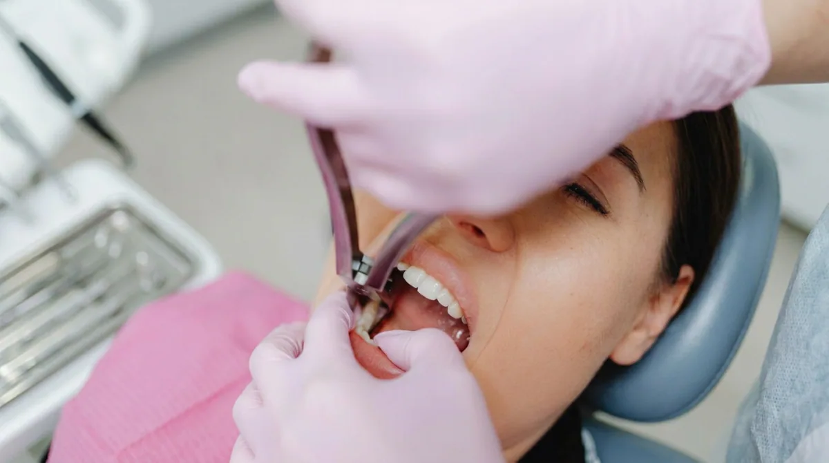 A dental professional performing wisdom tooth extraction with specialized instruments in a North York dental clinic