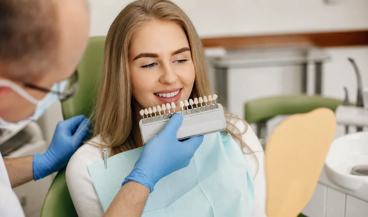 Dental veneers consultation in North York — dentist reviewing veneer shade options with a patient